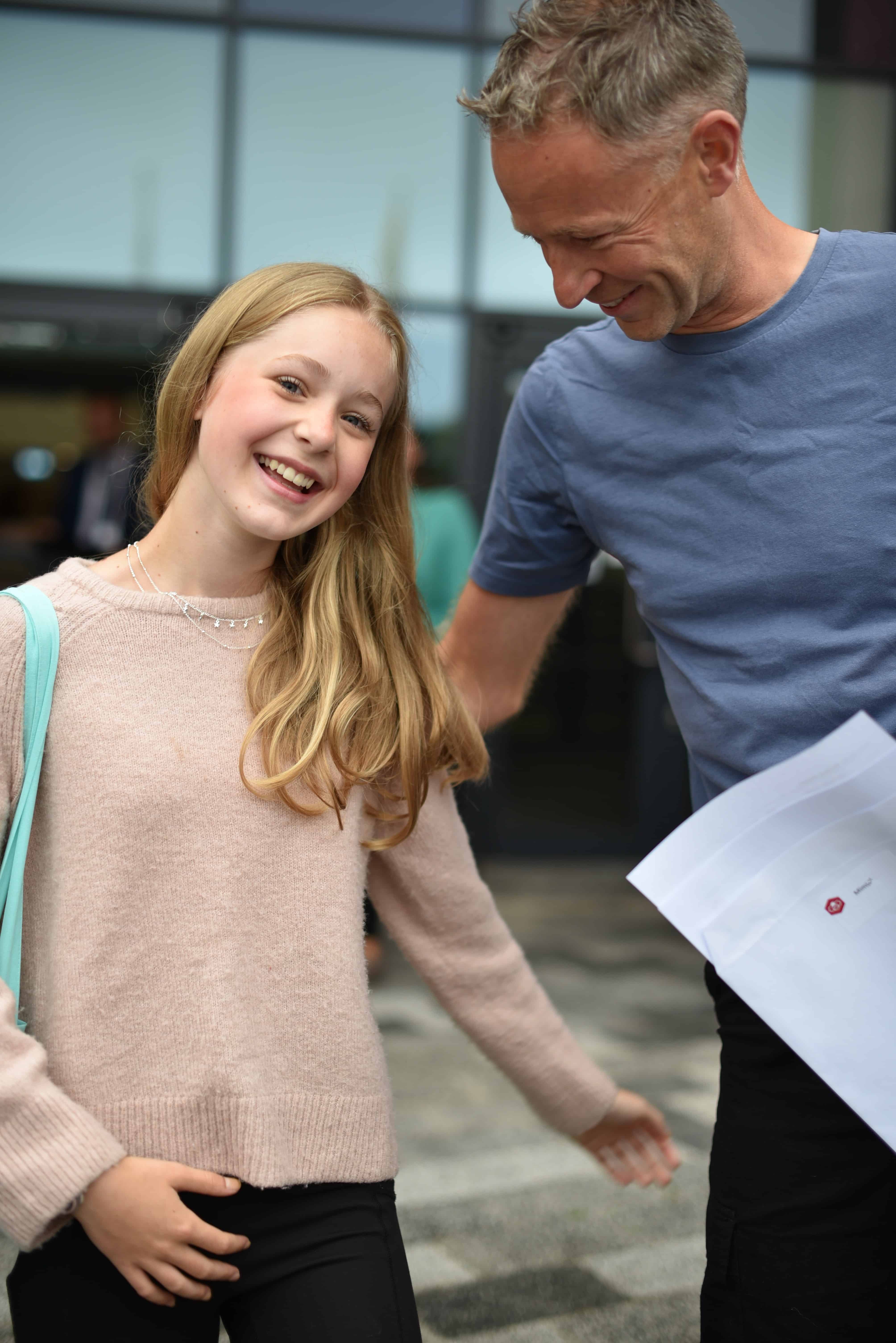 A Didsbury High School student smiles with a proud family member after finding out her GCSE results.