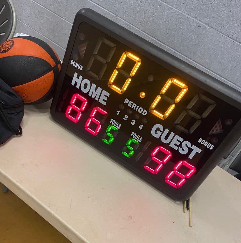 The scoreboard in the Basketball England U16s quarter final match between Didsbury High School and  Christopher Whitehead College. It shows 86 to CWC and 98 to DHS.