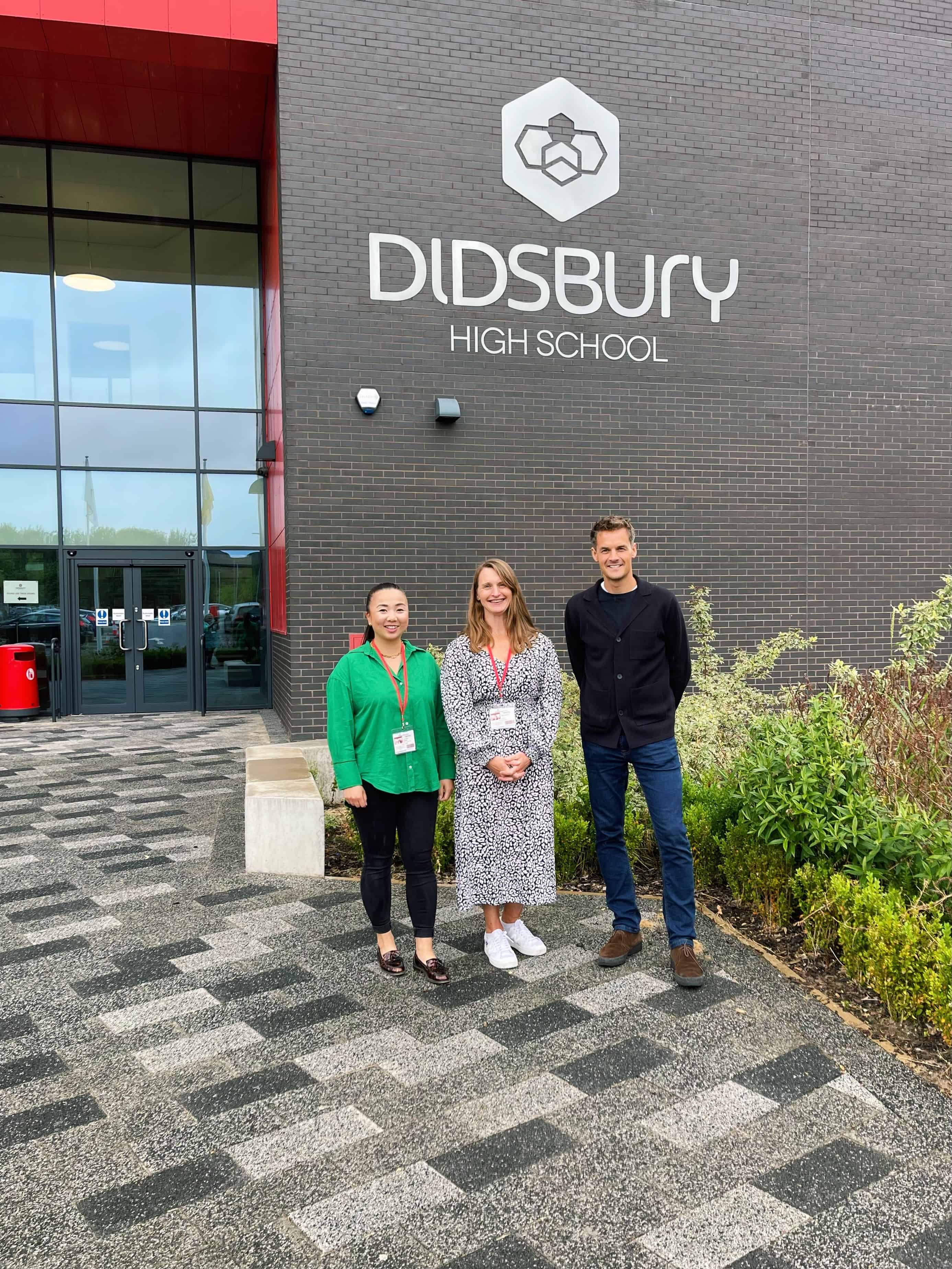 Renaker employees stand outside of Didsbury High School after delivering an Eco Classroom workshop by Class of Your Own as part of the DEC programme.