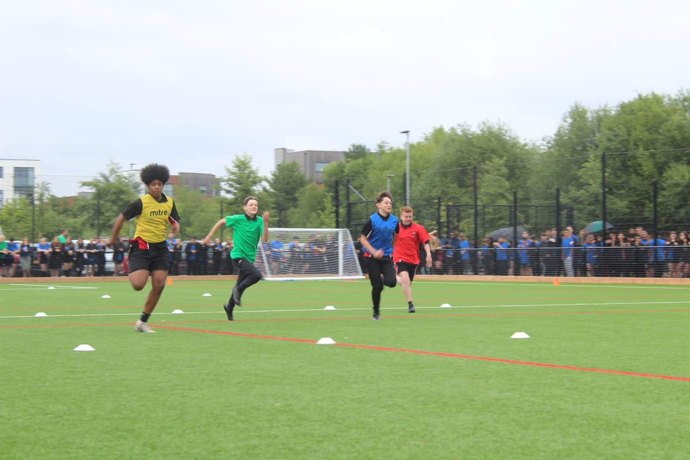 Students from Didsbury High School run on the 3G pitch in a race on Sports Day.