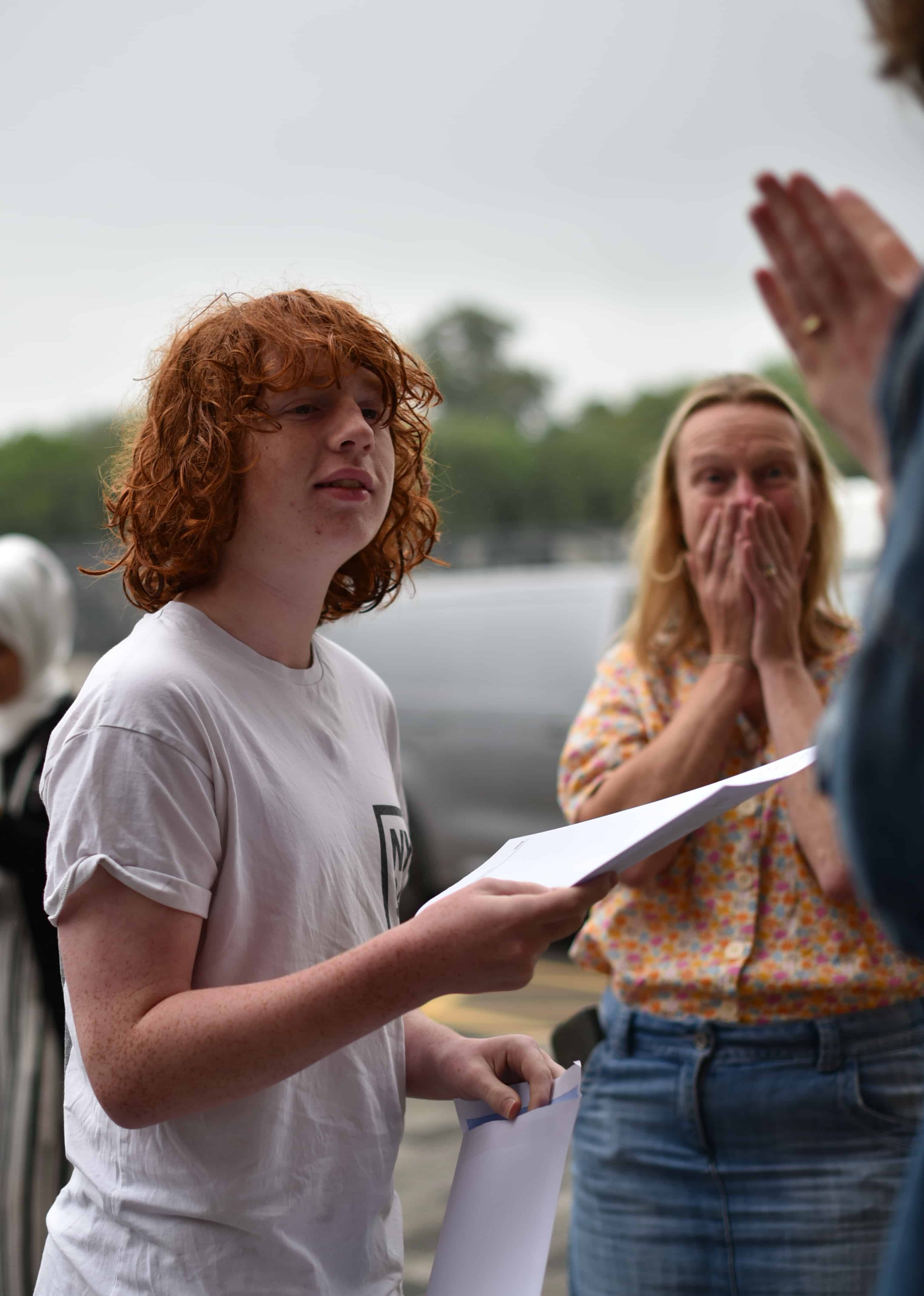 A Didsbury High School student is pleasantly surprised with his GCSE results, as his family look on excitedly while he announces his grade.