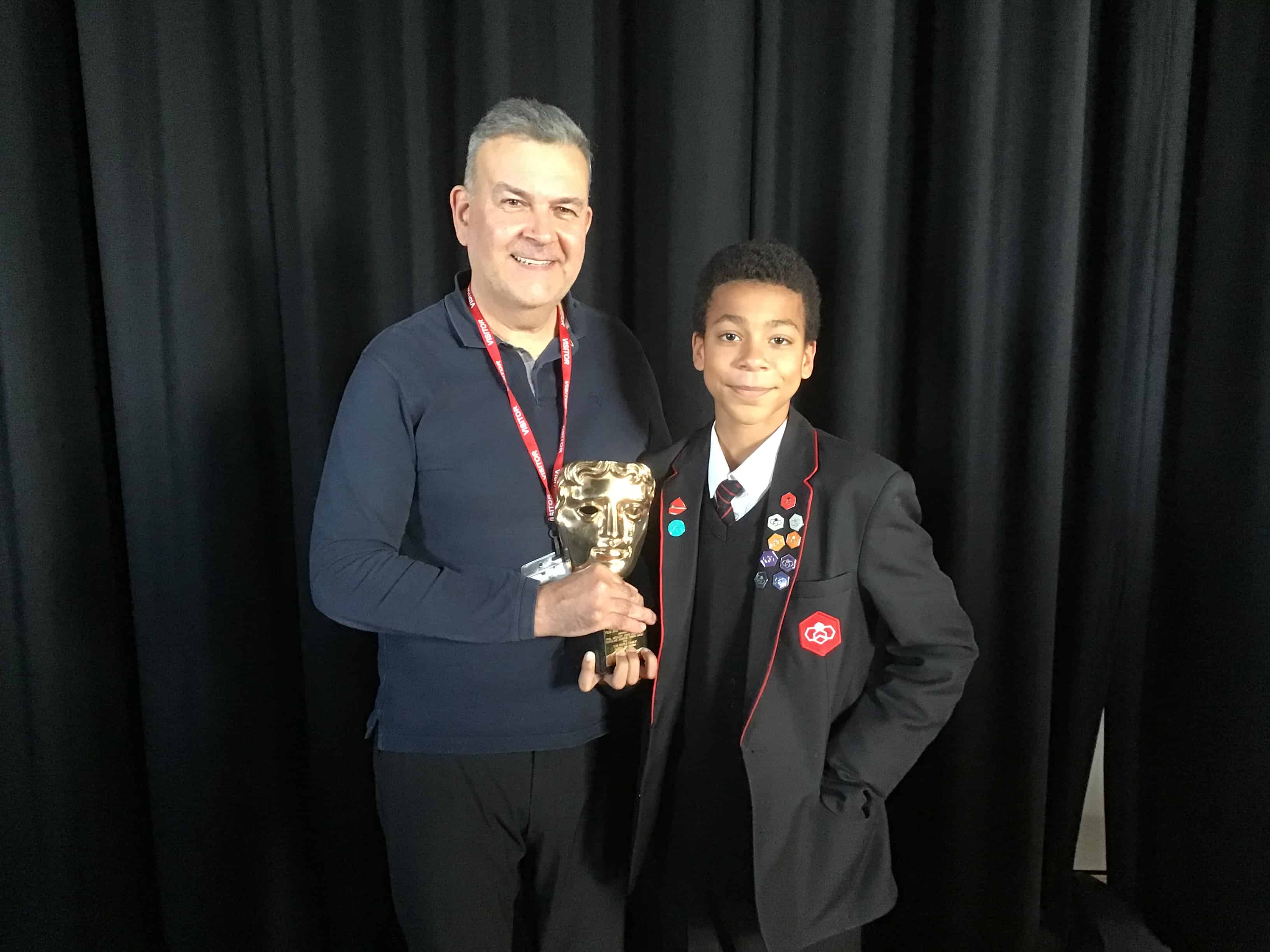 A student from Didsbury High School poses with Phil Mealey and his BAFTA award.