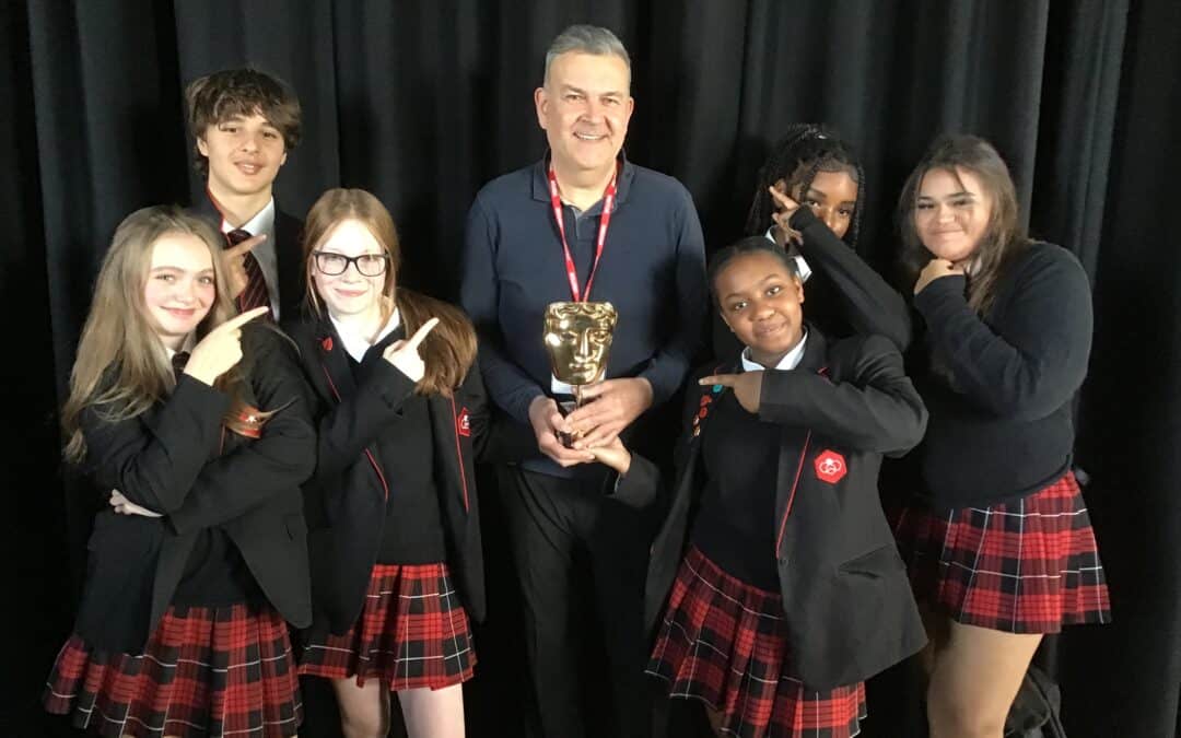 6 students from Didsbury High School pose with Phil Mealey and his BAFTA award.