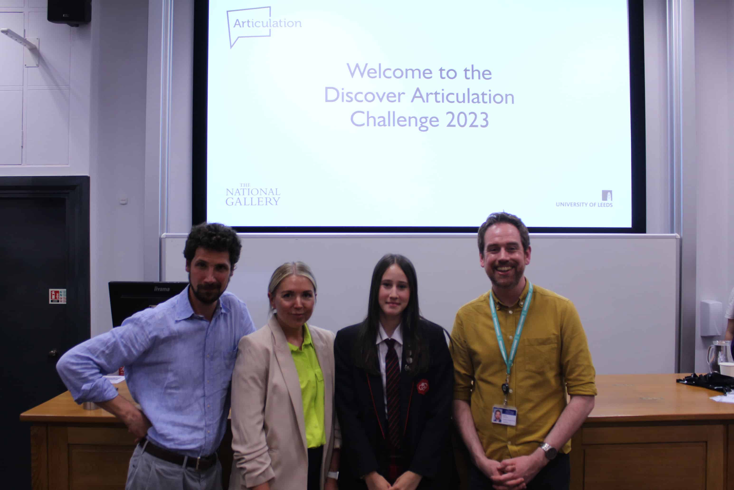 - Didsbury High School The judges of the Discover Articulation challenge, Mrs Patton (Lyla's art teacher) and Didsbury High School student Lyla stand together smiling in front of a projector screen which reads: "Welcome to the Discover Articulation Challenge 2023"