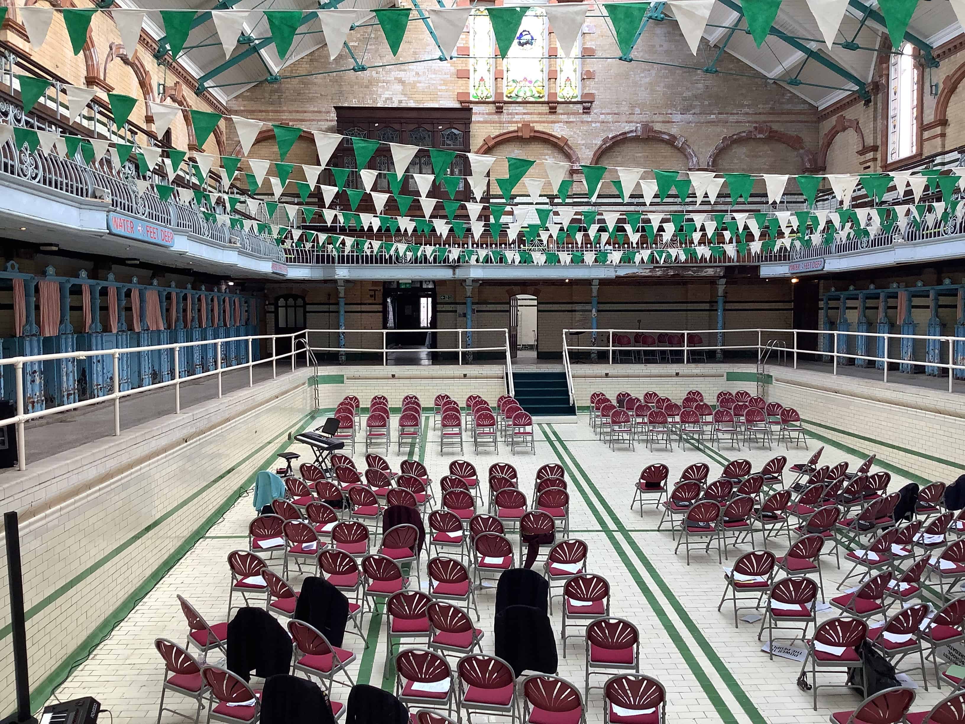 The Victoria Baths venue on the day of the One Education Vocal Showcase that Didsbury High School was part of. The 'bath' is full of seats.