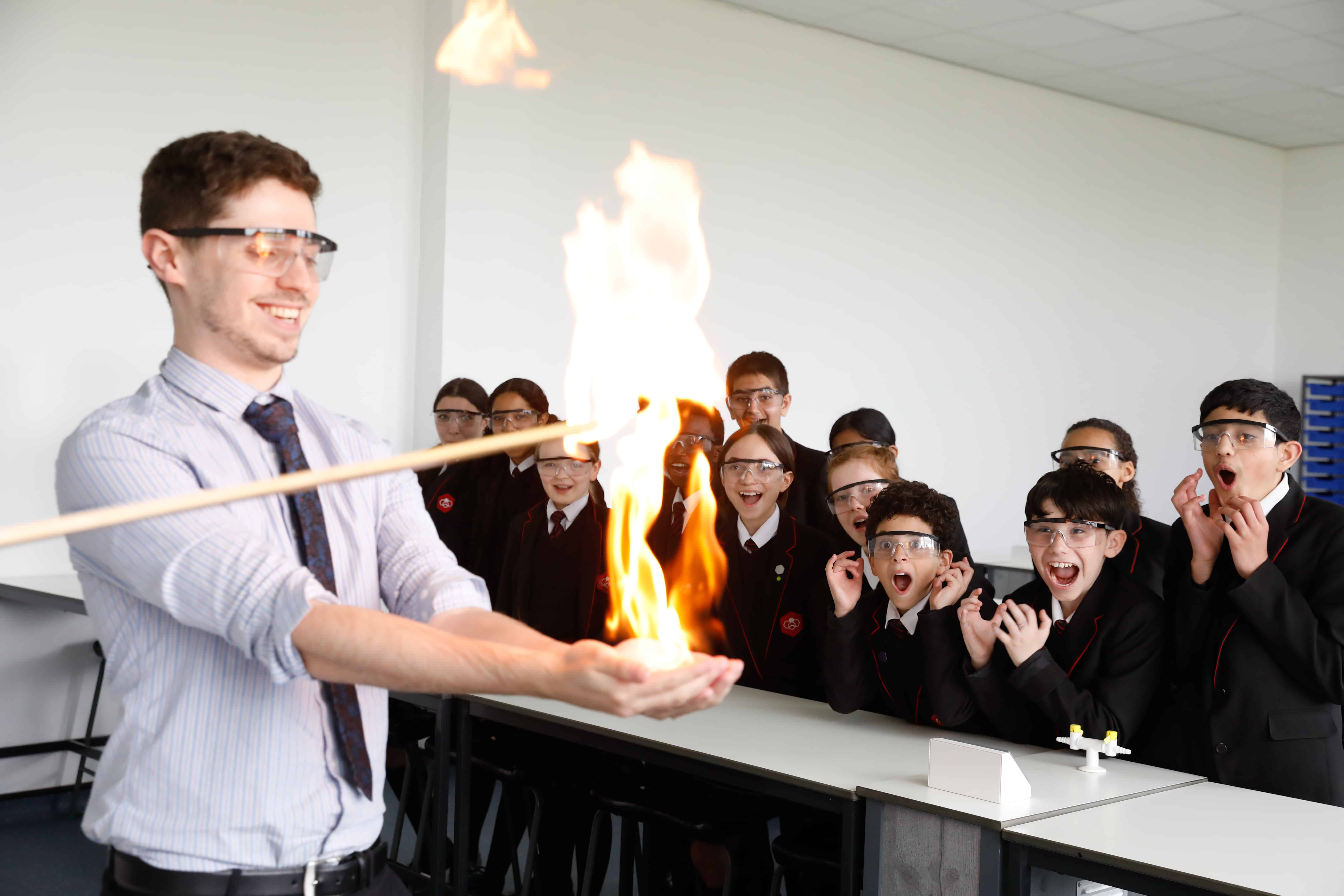 Image of a Didsbury High School teacher delivering a science experiment to students.