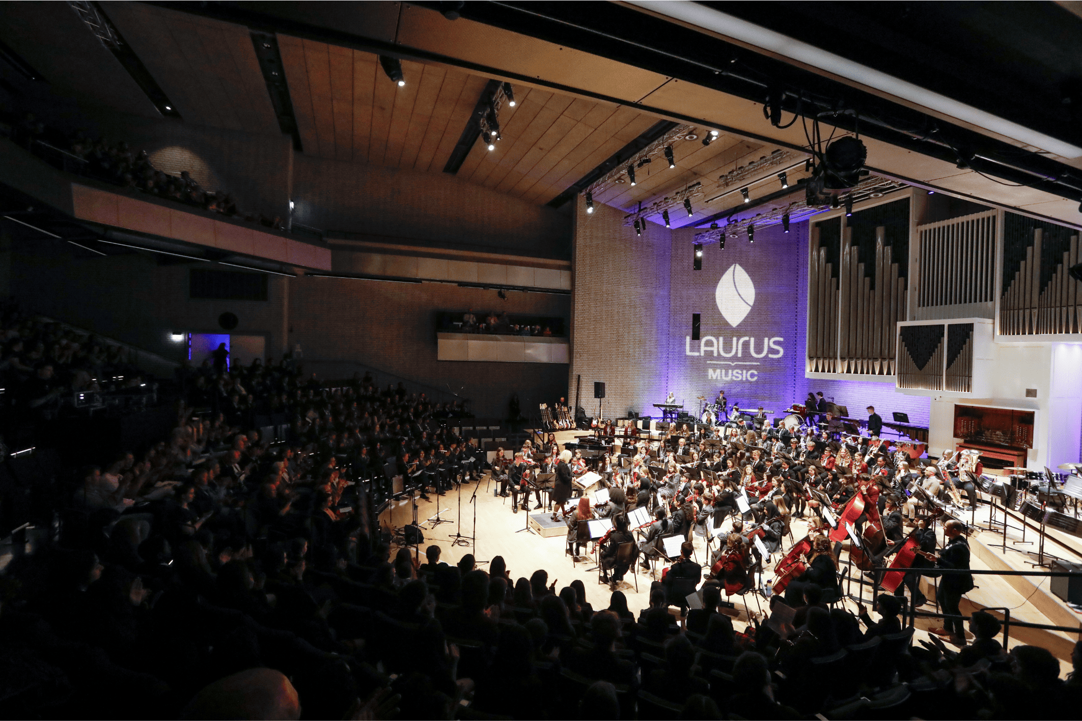 Students from Didsbury High School and the wider Laurus Trust came together at RNCM for Laurus Live. A wide shot shows the huge venue, the stage full of students and the audience.